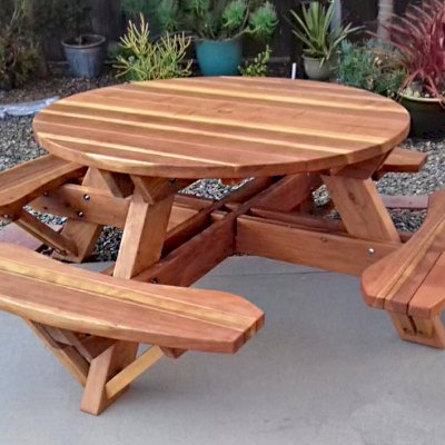 Round Wooden Picnic Tables (Attached Benches) (Options: 4.5' Diameter, Attached Benches, California Redwood, Standard Tabletop, No Lazy Susan, 1 5/8" Diameter Umbrella Hole & Plug, Transparent Premium Sealant). Photo Courtesy of B. Shushan of Carlsbad, CA.